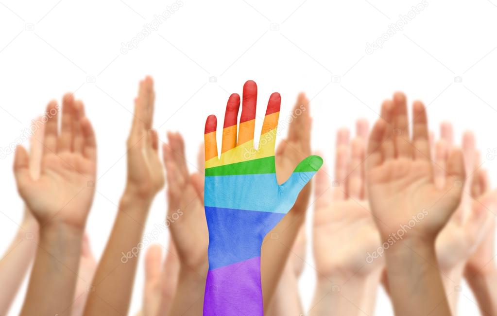 Man's hand painted as the rainbow flag on other hands background isolated on white