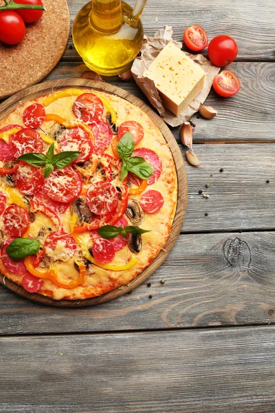 Delicious pizza served on wooden table — Stock Photo, Image