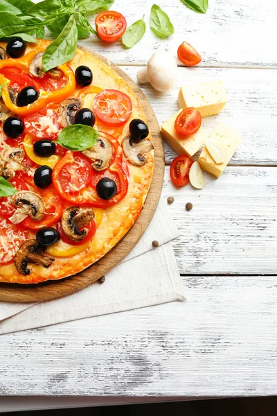 Läcker pizza serveras på träbord — Stockfoto