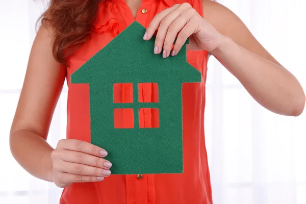 Woman hands holding paper house on light background — Stock Photo, Image