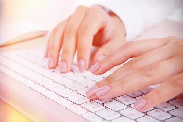 Female hands typing on keyboard on light background — Stock Photo, Image