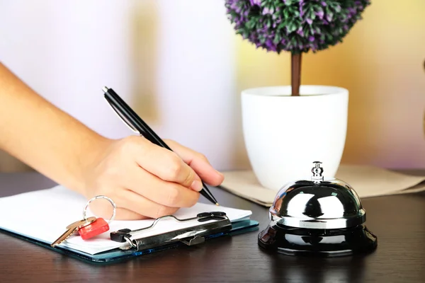 Female hand  writing in Hotel guest book — Stock Photo, Image