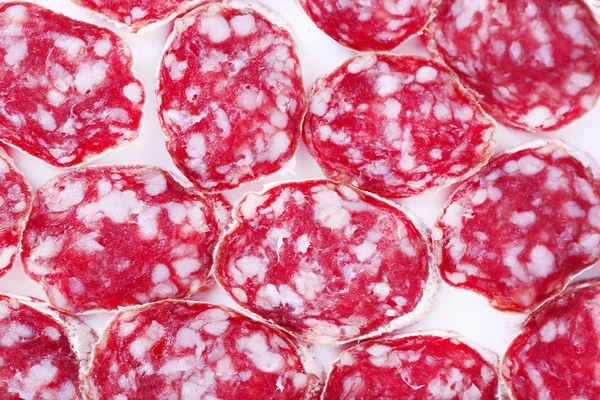 Slices of salami as background — Stock Photo, Image