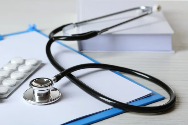 Medical stethoscope with book and folder — Stock Photo, Image