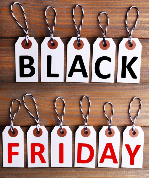 Black Friday text, Letters on labels on wooden background — Stock Photo, Image