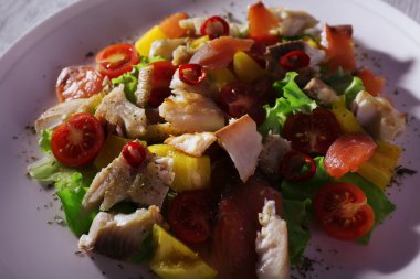 Ahşap masa yakın çekim tabakta sebze taze balık salatası