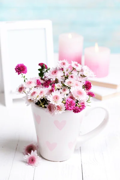 Beautiful flowers in cup — Stock Photo, Image