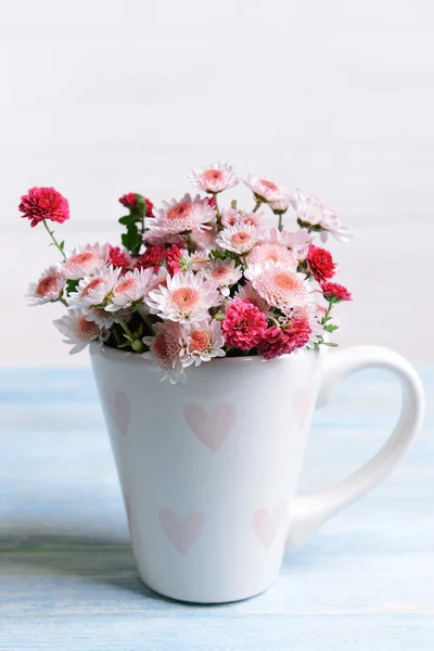 Beautiful flowers in cup — Stock Photo, Image