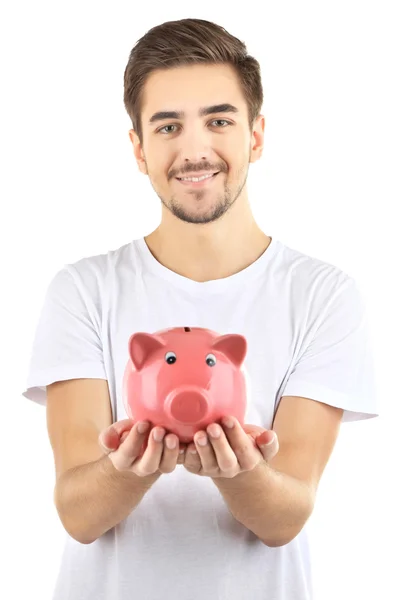 Bonito jovem com banco porquinho isolado em branco — Fotografia de Stock