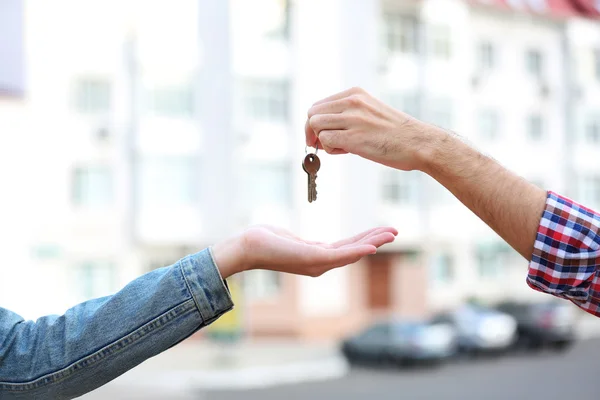 Man and woman hands hold keys