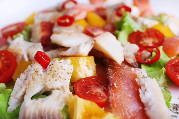 Appetizing fish salad with vegetables on plate close-up background — Stock Photo, Image