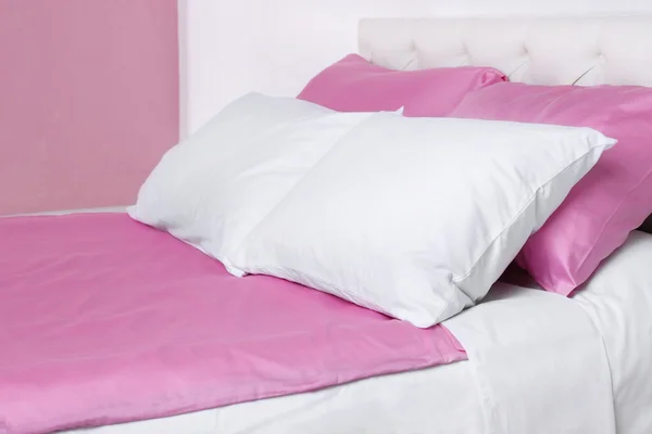 Bed in roze beddengoed — Stockfoto