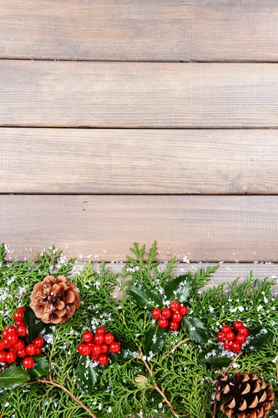 Beautiful Christmas border from fir and mistletoe on wooden background — Stock Photo, Image