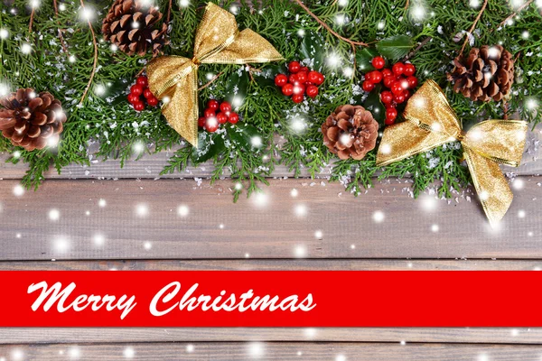 Beautiful Christmas border from fir and mistletoe on wooden background — Stock Photo, Image