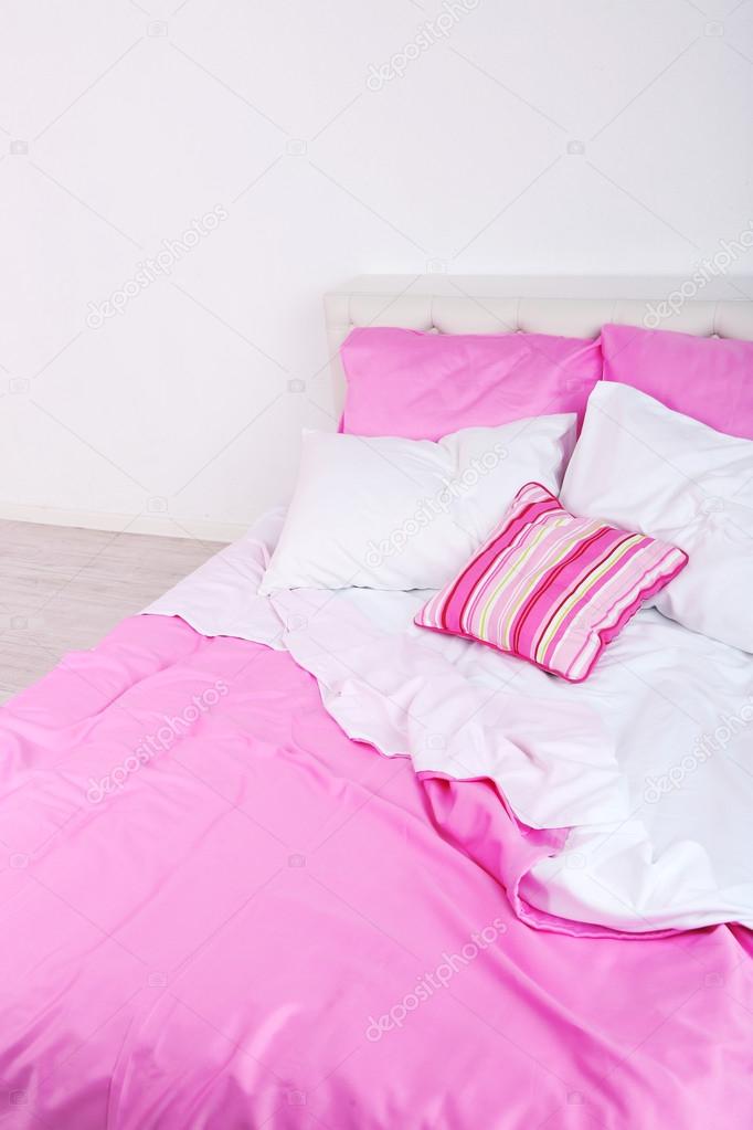Bed in pink bed linen
