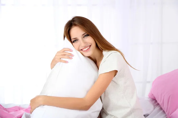 Young beautiful woman sitting on bed — Stock Photo, Image