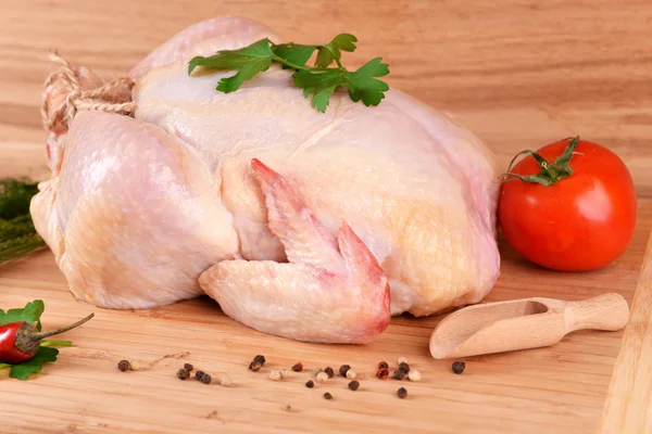 Сырая курица на деревянном столе — стоковое фото
