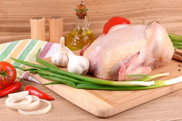 Raw chicken on wooden table — Stock Photo, Image