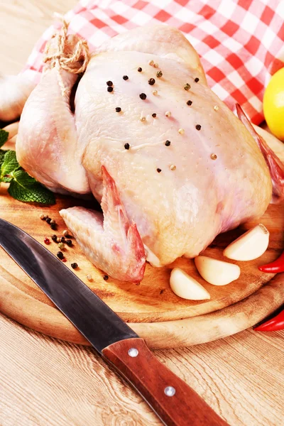 Raw chicken on wooden table — Stock Photo, Image
