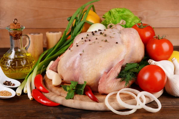 Raw chicken on wooden table — Stock Photo, Image