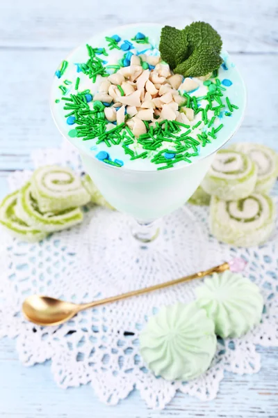 Mint milk dessert in glass bowl on color wooden background — Stock Photo, Image