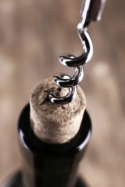 Bottle opener close-up, on wooden background — Stock Photo, Image