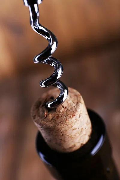 Bottle opener close-up, on wooden background — Stock Photo, Image