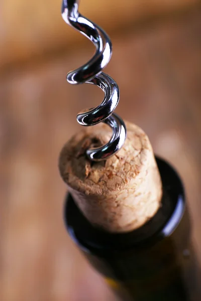 Bottle opener close-up, on wooden background — Stock Photo, Image