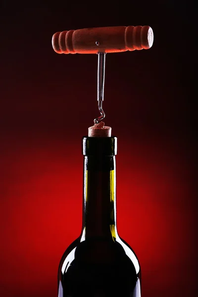 Ouverture de bouteille en gros plan, sur fond de couleur sombre — Photo