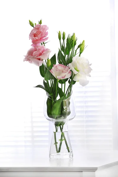 Beautiful flowers in vase on light background — Stock Photo, Image