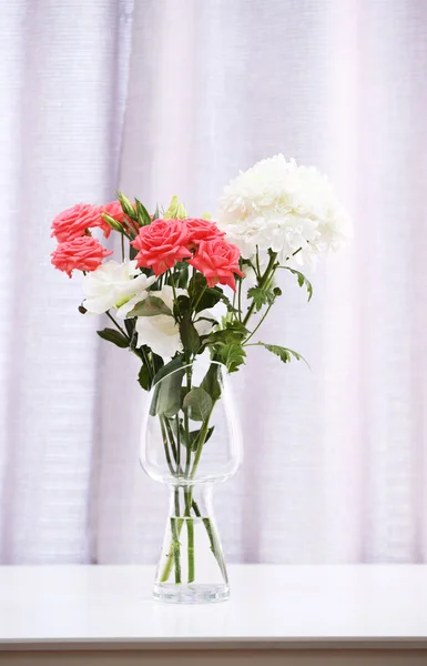 Beautiful flowers in vase on curtains background — Stock Photo, Image