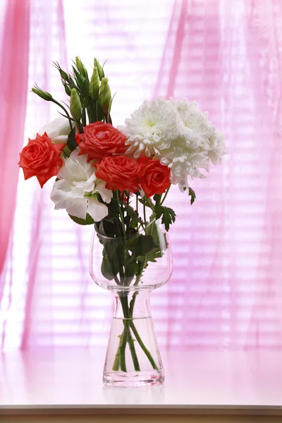 Beautiful flowers in vase with light from window — Stock Photo, Image