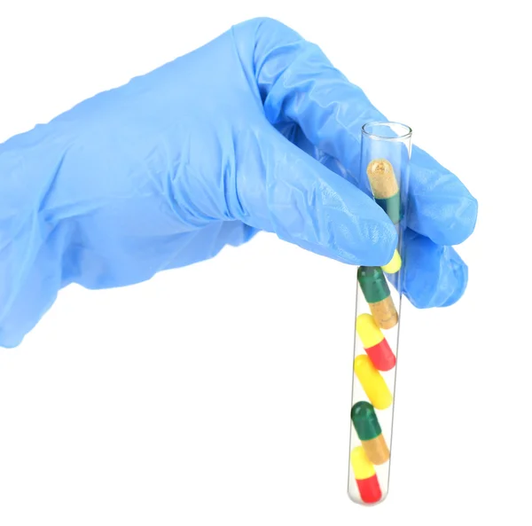 Hand holding test tube with different color drugs, isolated on white — Stock Photo, Image