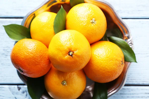 Tangerines with leaves on plate — Stock Fotó