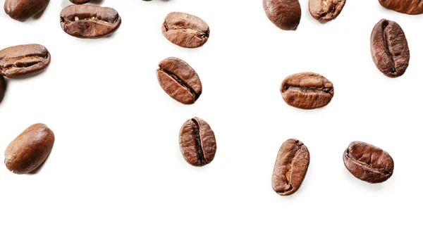 Grãos de café na mesa branca, close-up — Fotografia de Stock