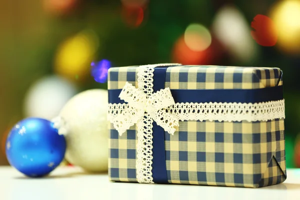 Gift box on Christmas tree — Stock Photo, Image