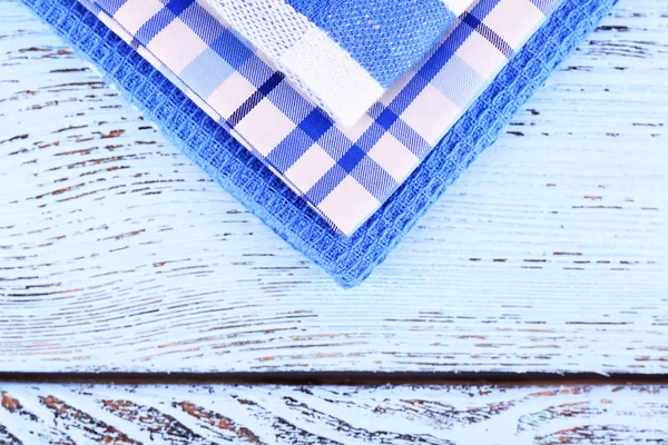 Blue napkins on wooden table — Stock Photo, Image