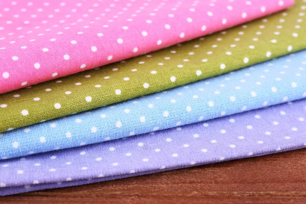 Colorful napkins on wooden table — Stock Photo, Image