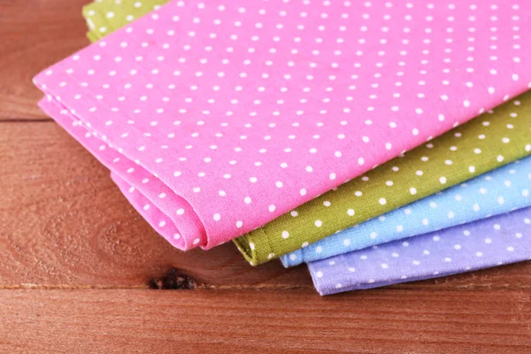 Colorful napkins on wooden table — Stock Photo, Image