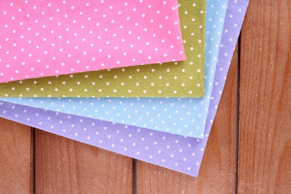 Colorful napkins on wooden table — Stock Photo, Image