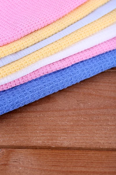 Colorful napkins on wooden table — Stock Photo, Image