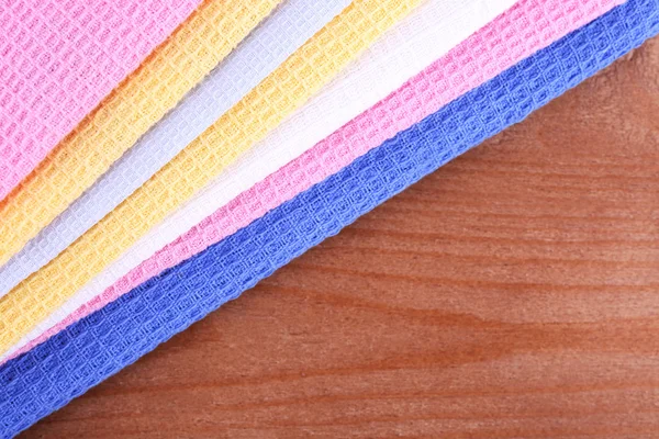 Colorful napkins on wooden table — Stock Photo, Image