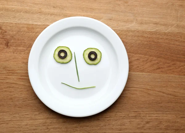 Vegetable face on plate — Stock Photo, Image