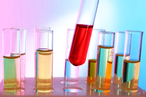 Test tube filled with red liquid on background of other tubes — Stock Photo, Image