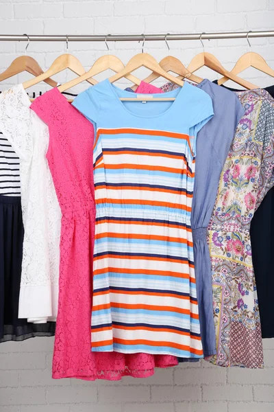 Female dresses on hangers in room — Stock Photo, Image