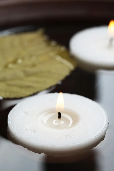 White candles floating in water Royalty Free Stock Images