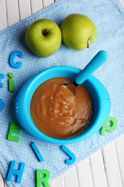 Fresh baby food in bowl with spoon — Stock Photo, Image
