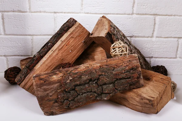 Logs in fireplace on brick wall background — Stock Photo, Image