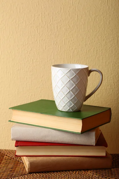 Pile of books with cup — Stock Photo, Image