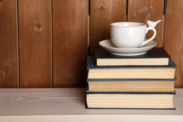 Pile of books with cup — Stock Photo, Image